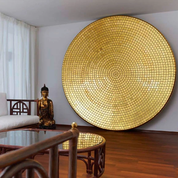 Large circular gold mosaic artwork in an interior