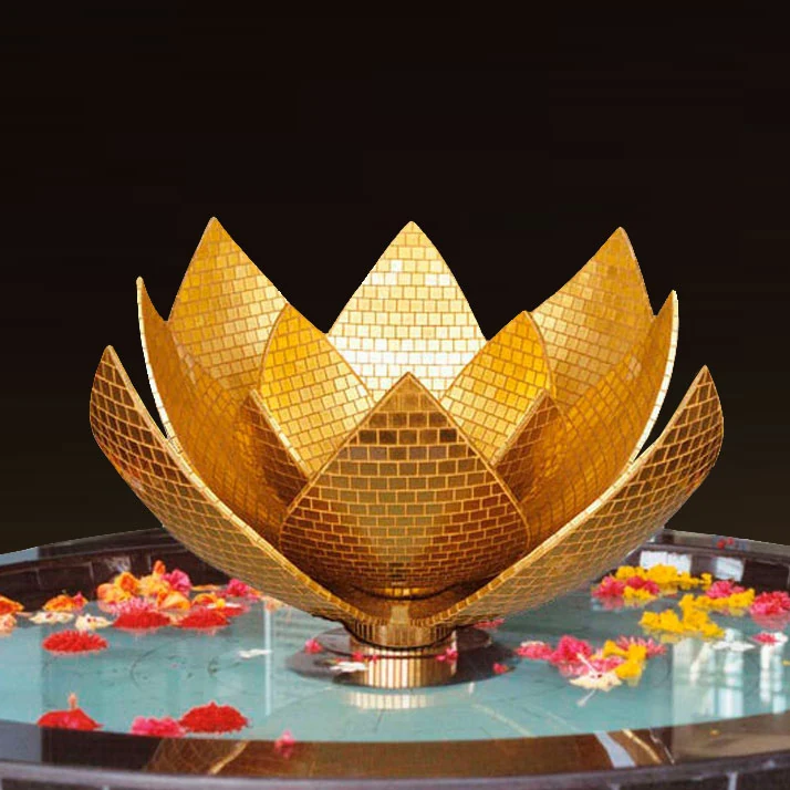 Sculptural gold lotus installation in a reflecting pond