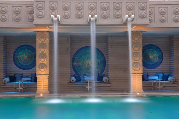 Hotel interior with circular mosaic artworks above water