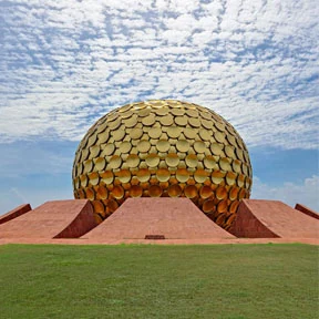 Matrimandir in Auroville beneath a blue sky