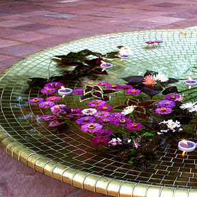 Circular gold mosaic installation in water